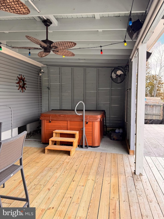 deck with ceiling fan and a hot tub