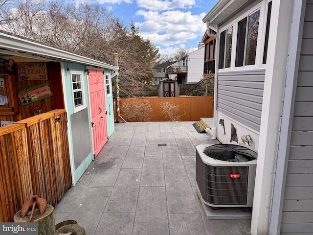 view of patio featuring cooling unit and fence