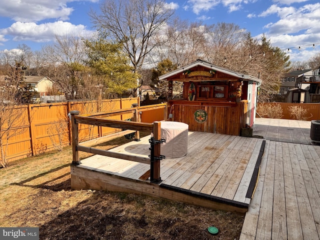 wooden deck featuring central air condition unit and a fenced backyard