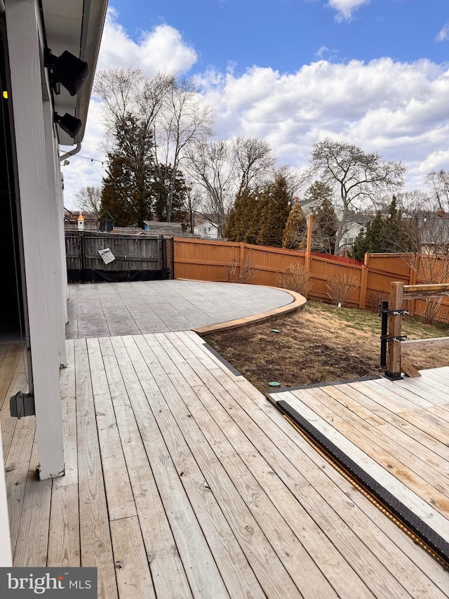 wooden deck featuring a patio and a fenced backyard