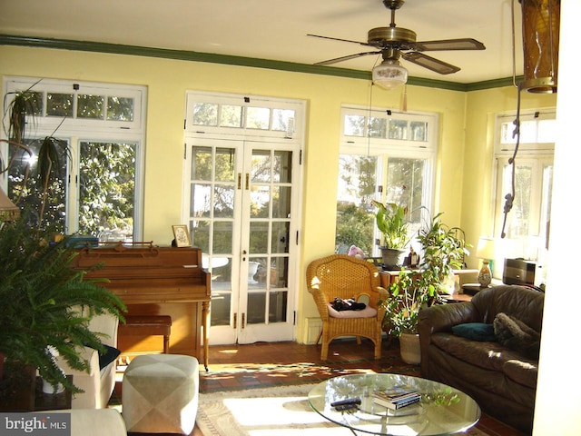 sunroom / solarium featuring french doors and ceiling fan