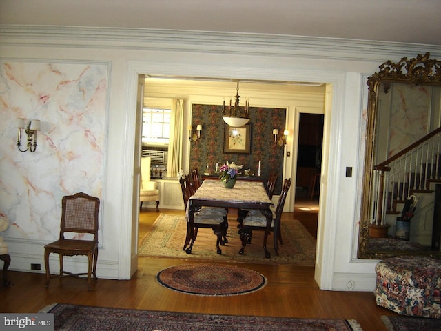 dining room featuring crown molding and dark hardwood / wood-style floors