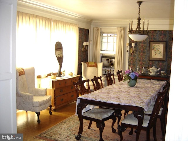 dining room with hardwood / wood-style floors and crown molding