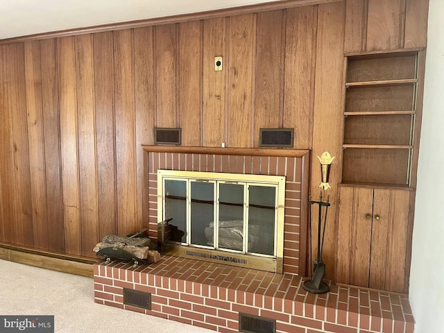 room details featuring carpet flooring and wood walls