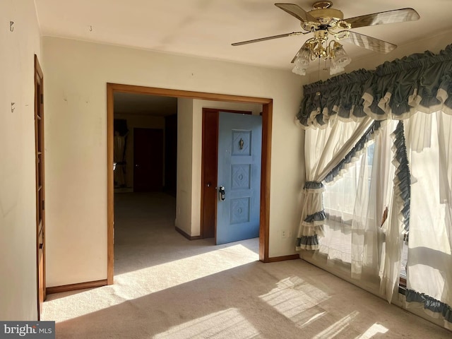 empty room with light carpet and ceiling fan