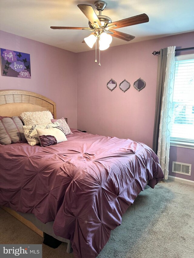 carpeted bedroom featuring ceiling fan