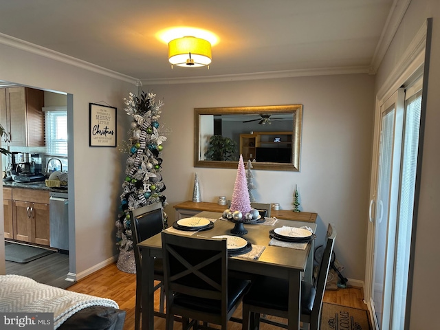 dining area with hardwood / wood-style flooring and ornamental molding