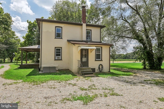 back of house featuring a yard