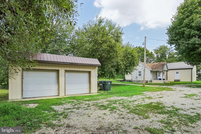 view of yard with an outbuilding and a garage