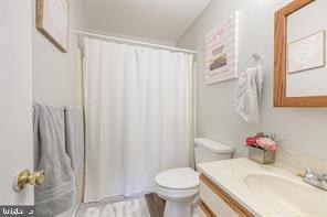 bathroom featuring vanity and toilet