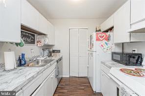 kitchen featuring white cabinetry, white fridge, stainless steel dishwasher, and dark hardwood / wood-style flooring