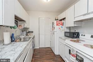 kitchen with light stone counters, sink, white appliances, and white cabinets