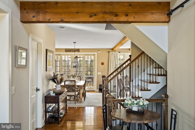 dining area featuring dark hardwood / wood-style flooring, an inviting chandelier, and beam ceiling