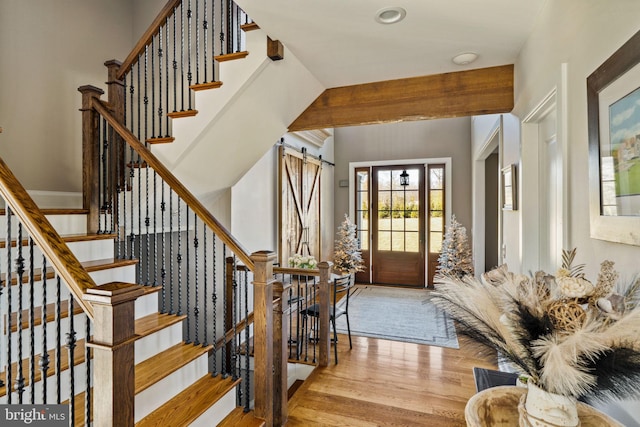 foyer featuring light hardwood / wood-style flooring and a barn door