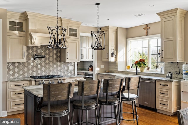 kitchen featuring hanging light fixtures, a kitchen island, dark hardwood / wood-style floors, and appliances with stainless steel finishes