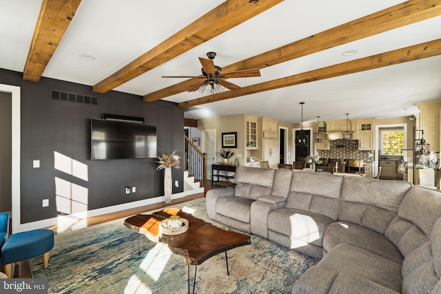 living room featuring beam ceiling and ceiling fan