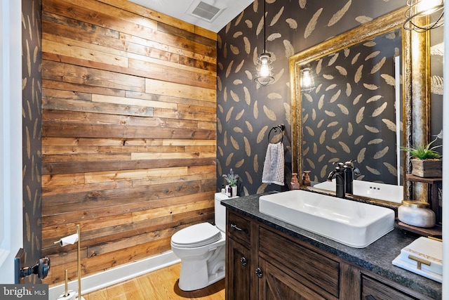 bathroom with vanity, hardwood / wood-style floors, and toilet