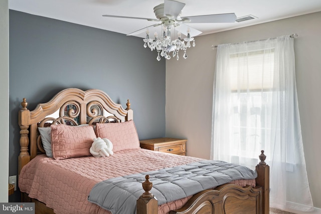 carpeted bedroom with multiple windows and ceiling fan