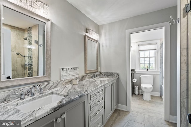 bathroom featuring vanity, toilet, and a shower with shower door