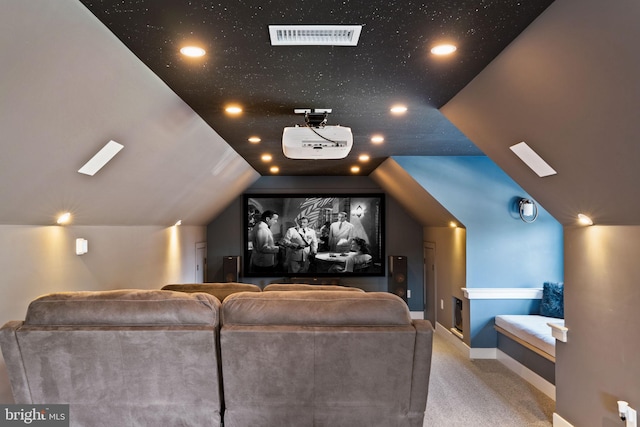 carpeted home theater featuring vaulted ceiling