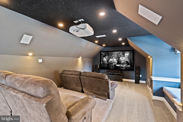 cinema room featuring lofted ceiling and carpet floors