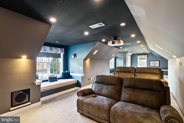 home theater with vaulted ceiling and carpet floors