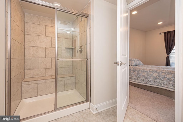 bathroom with tile patterned flooring and a shower with door