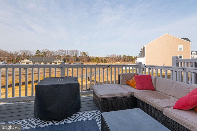 wooden deck with an outdoor living space