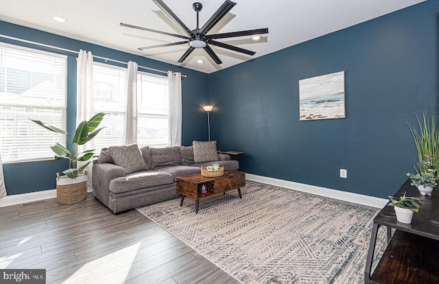 living room featuring ceiling fan and hardwood / wood-style floors