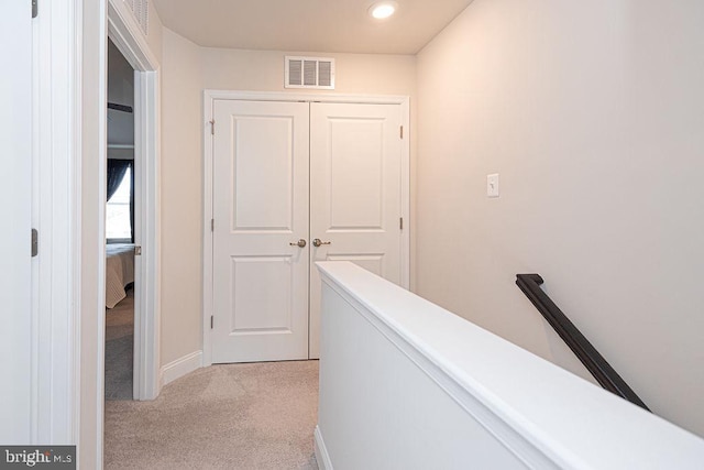 corridor with light colored carpet