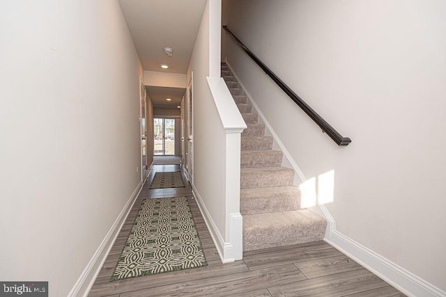 stairs featuring hardwood / wood-style flooring