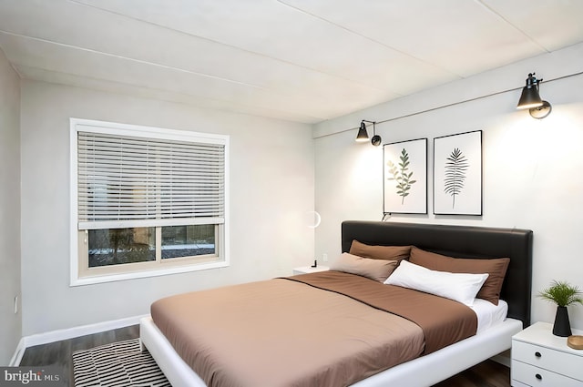 bedroom with dark wood-style floors and baseboards