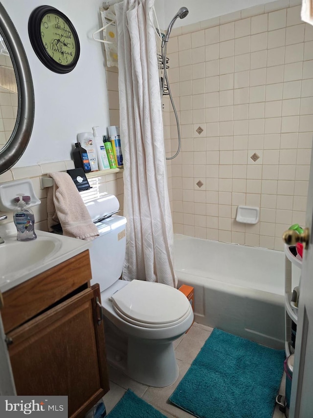 full bathroom with shower / bath combo, vanity, tile patterned floors, and toilet