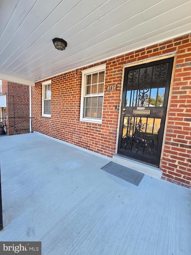 view of exterior entry featuring a porch