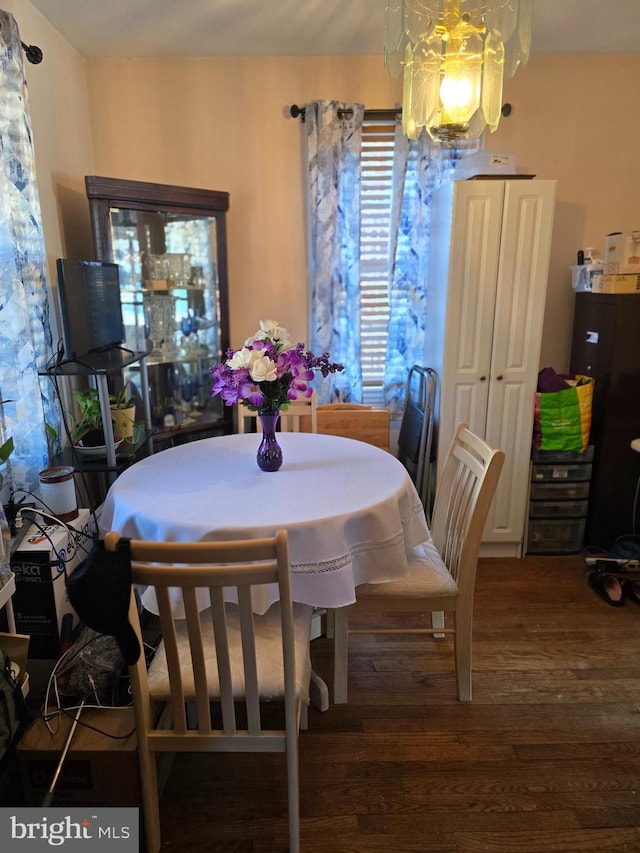 dining room featuring dark wood-type flooring and a notable chandelier