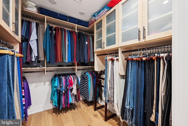 spacious closet with light hardwood / wood-style flooring