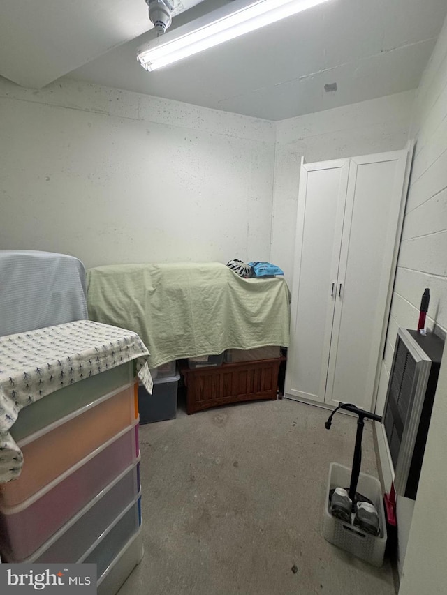 bedroom featuring unfinished concrete floors