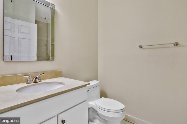 bathroom with vanity, tile patterned flooring, and toilet