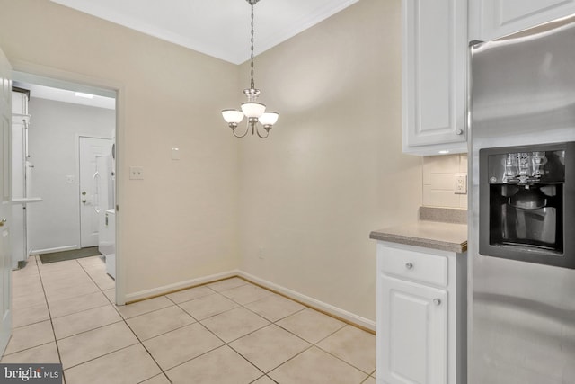 unfurnished dining area featuring light tile patterned floors and a chandelier