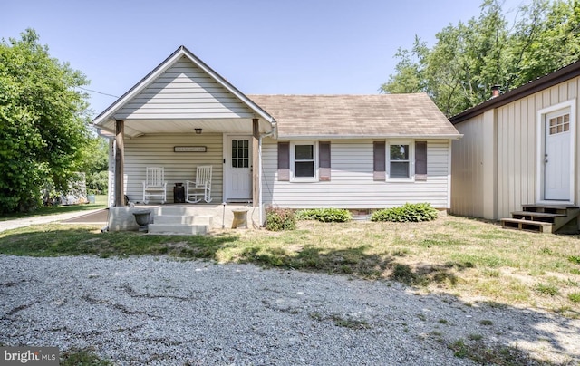 view of front of home with a porch and a front yard