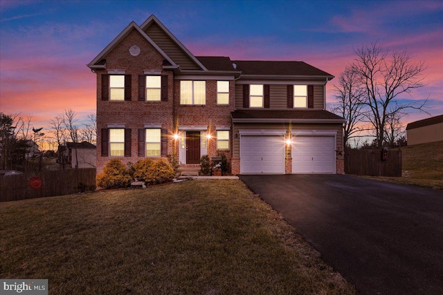 view of front of property with a yard and a garage