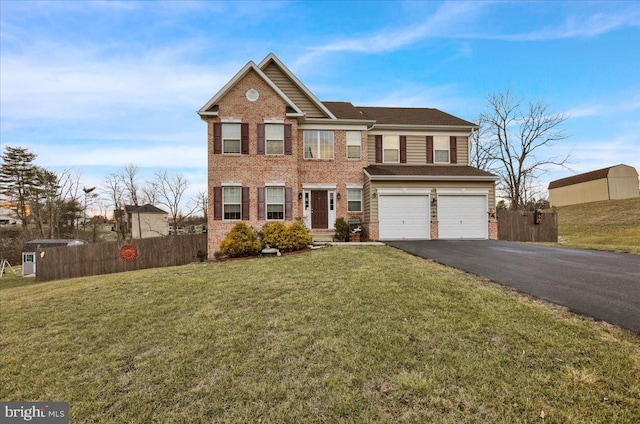 view of front of house featuring a garage and a front lawn