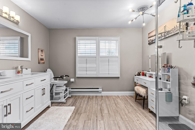 bathroom featuring a healthy amount of sunlight, a baseboard heating unit, hardwood / wood-style floors, and toilet