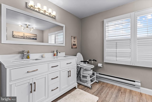 bathroom with a baseboard radiator, vanity, and hardwood / wood-style floors