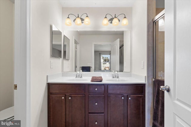 bathroom featuring vanity and a shower with shower door