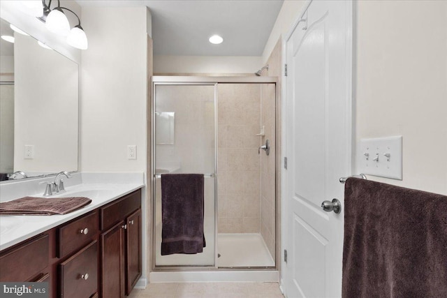 bathroom featuring vanity and a shower with shower door