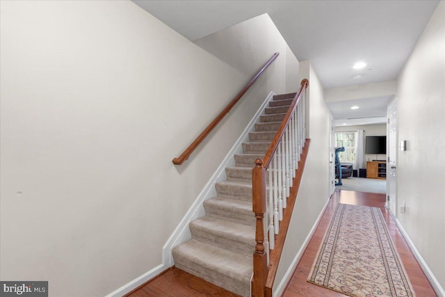 stairs featuring wood-type flooring