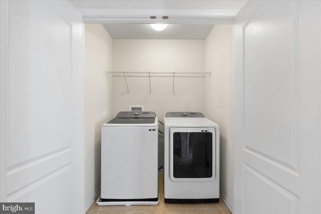 washroom featuring light tile patterned flooring and washing machine and clothes dryer