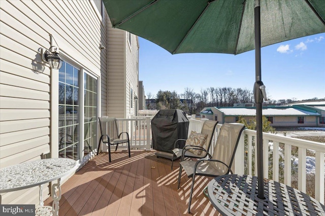 wooden terrace featuring grilling area