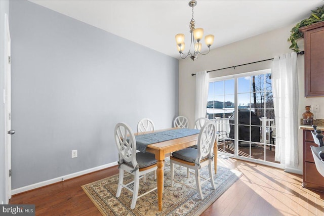 dining area featuring a chandelier and hardwood / wood-style floors